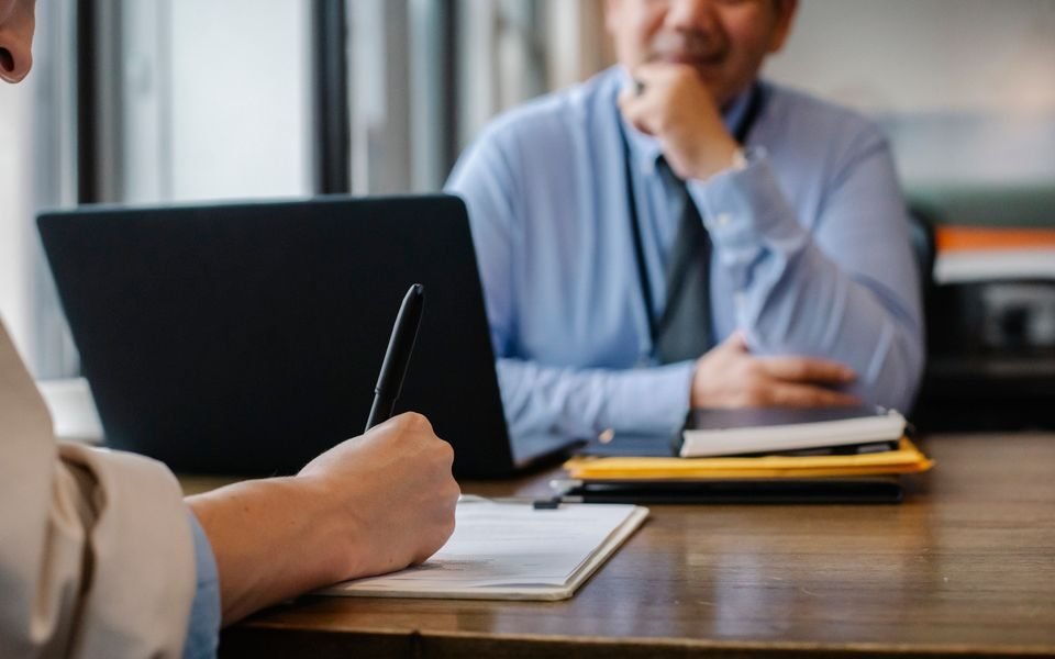 Candidate and interviewer reviewing application paperwork